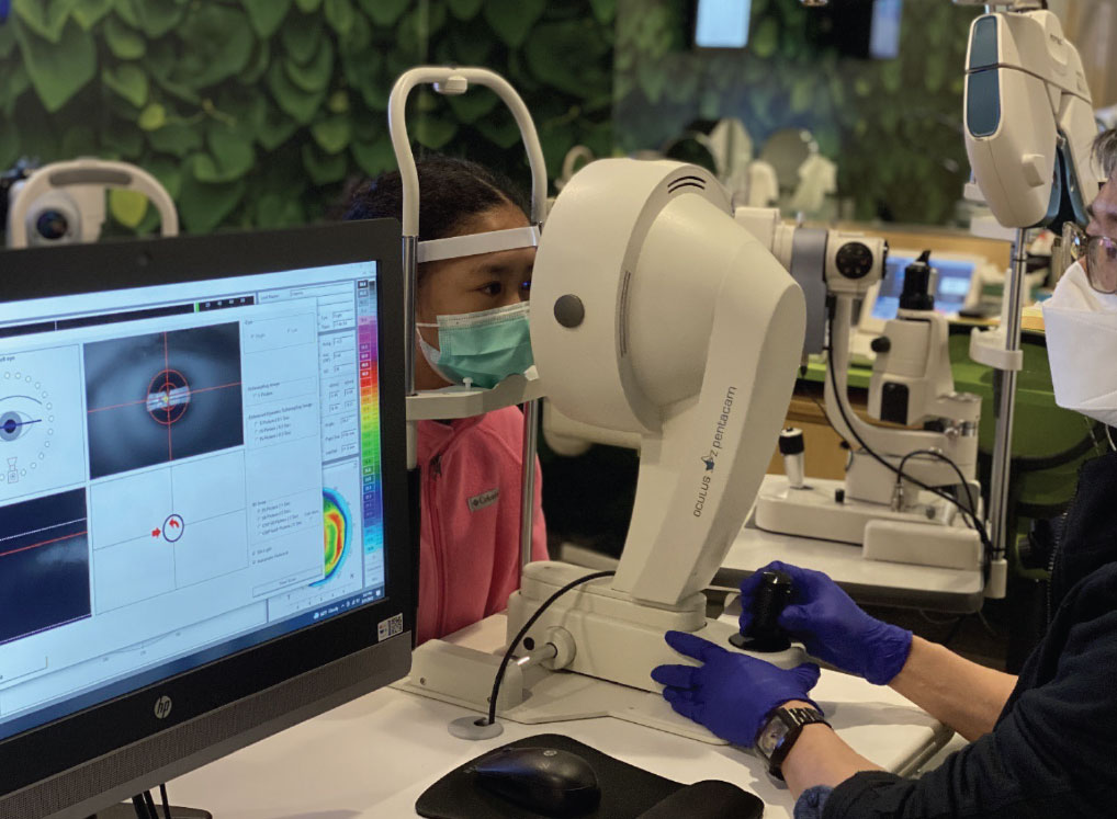 Another child was seen having a corneal tomography to reveal the anterior and posterior corneal status upon fitting with ortho-K lenses.